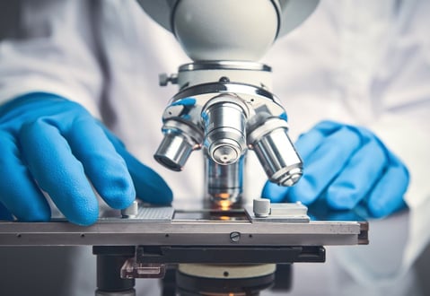 researcher using microscope